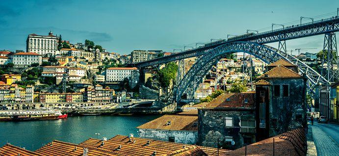 American expats walking through Lisbon streets with views over the Tagus river